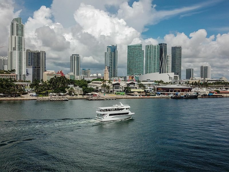 The downtown skyline from the bay by day, a cruise boat crossing in front