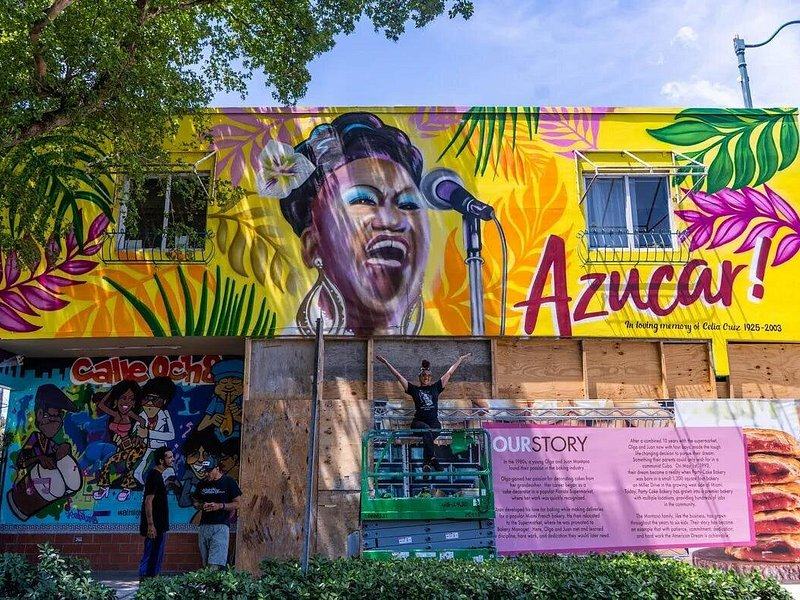 A bright mural of a singer on a wall in Little Havana